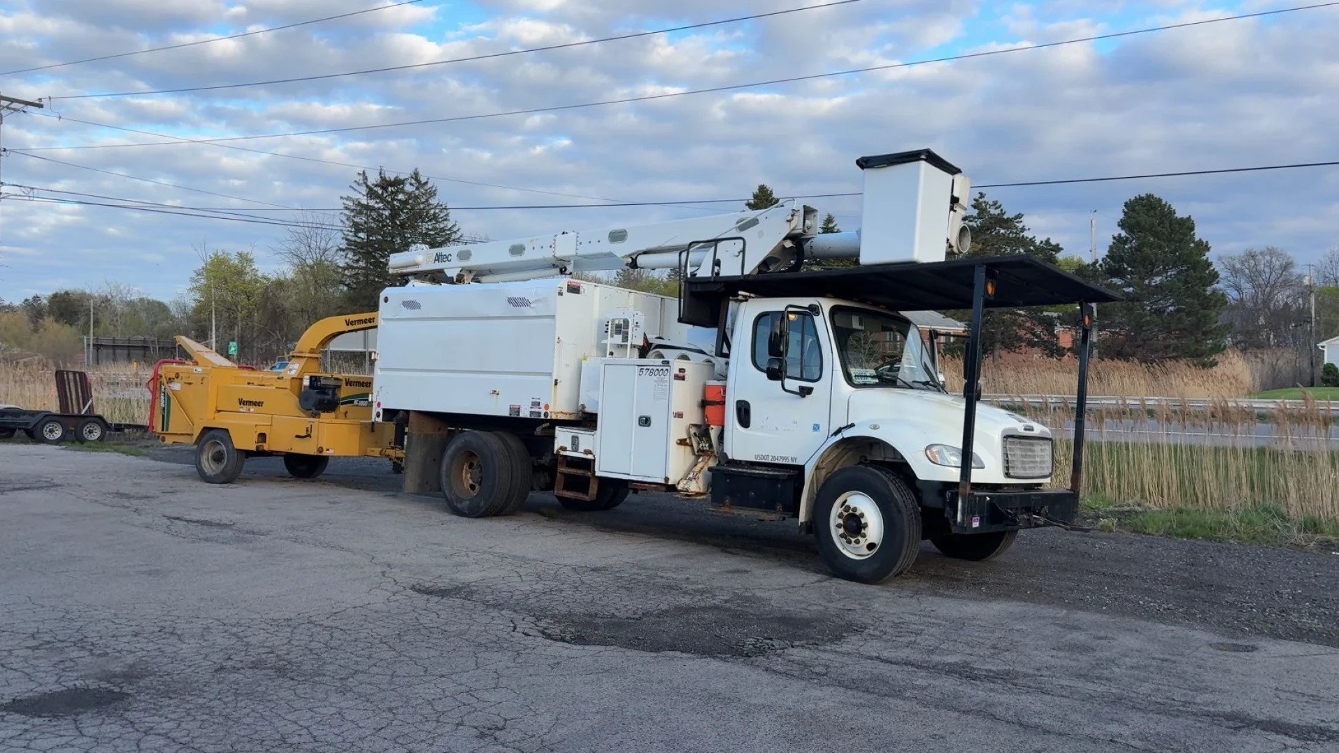 F&B Altec bucket truck hooked to a Vermeer chipper parked and ready for the next job